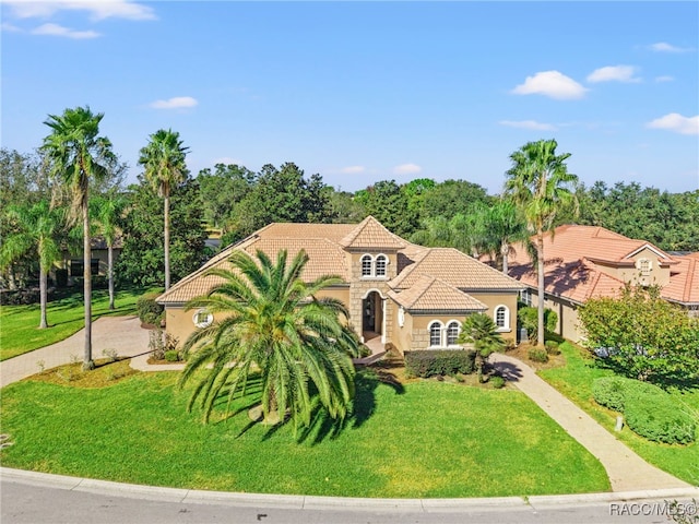 mediterranean / spanish-style home with a front lawn