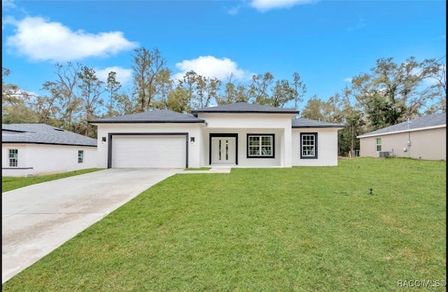 view of front of home featuring a garage and a front yard