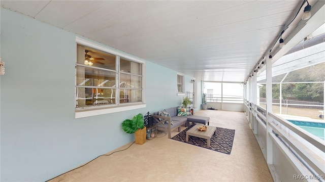 sunroom featuring ceiling fan