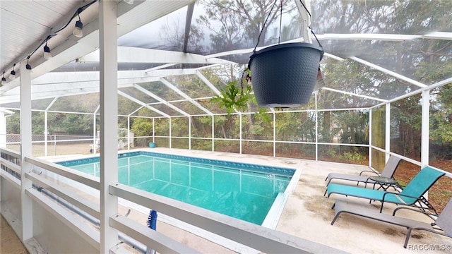 view of pool with a lanai and a patio area