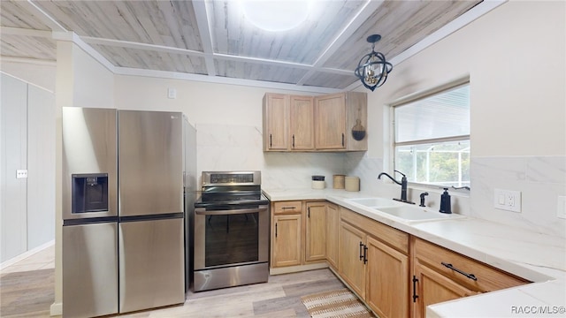 kitchen with sink, hanging light fixtures, light brown cabinets, and appliances with stainless steel finishes