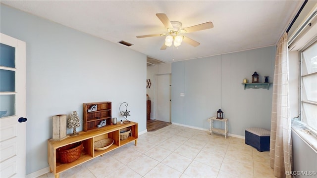 interior space with ceiling fan