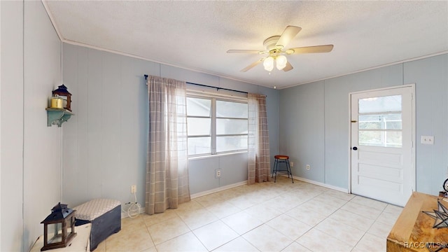 unfurnished room with ceiling fan and a textured ceiling