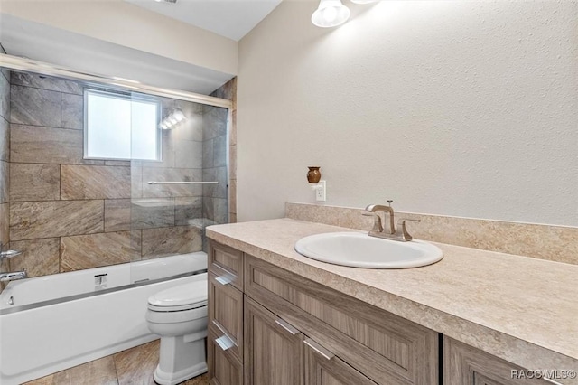 full bathroom with vanity, enclosed tub / shower combo, and toilet