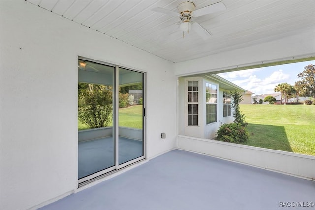 unfurnished sunroom with ceiling fan