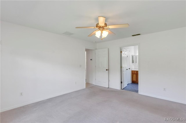 carpeted spare room featuring ceiling fan