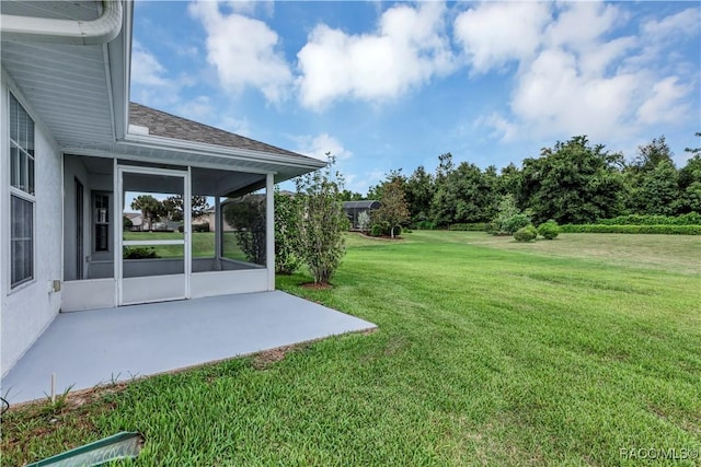 view of yard with a sunroom and a patio