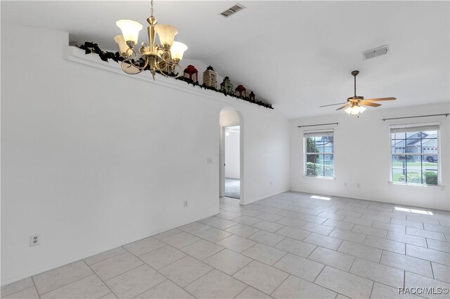 unfurnished room featuring ceiling fan with notable chandelier, light tile patterned floors, and vaulted ceiling