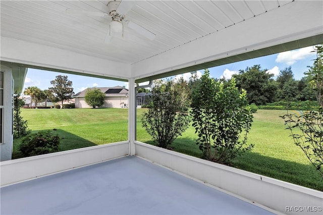 unfurnished sunroom with ceiling fan