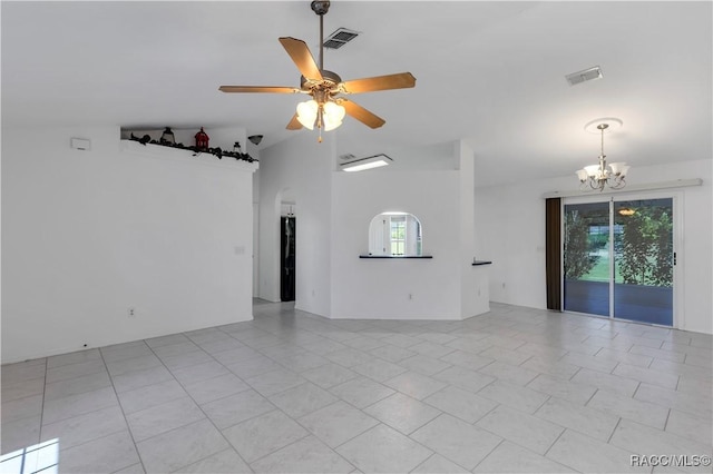 spare room with plenty of natural light, light tile patterned flooring, lofted ceiling, and ceiling fan with notable chandelier