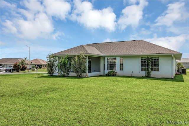 single story home with a front yard and cooling unit