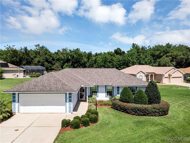 ranch-style house featuring a front yard and a garage