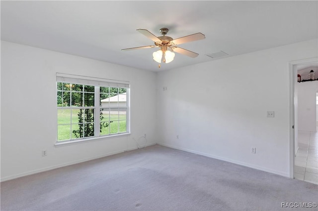 empty room with ceiling fan and light colored carpet