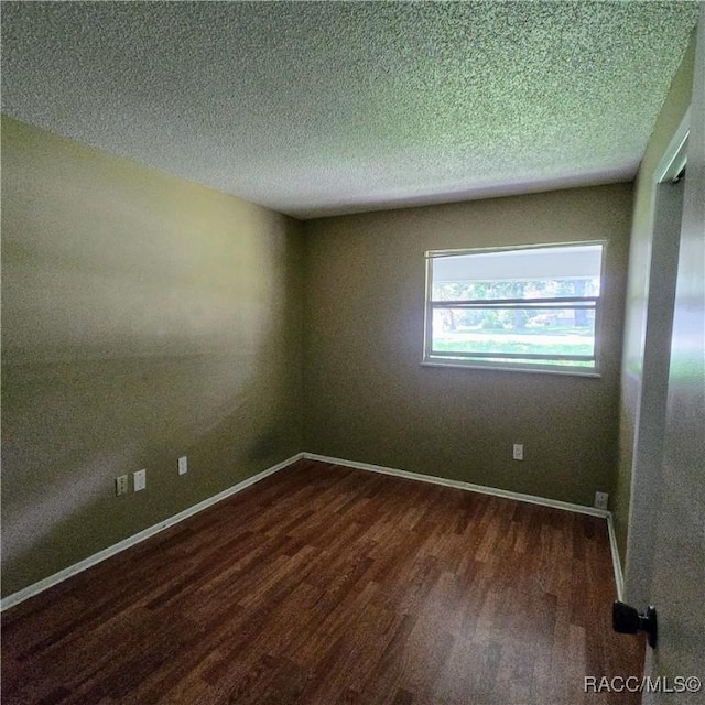 9227 N Fawn Way, Citrus Springs, FL 34434 - spare room with dark wood-style flooring and a textured ceiling