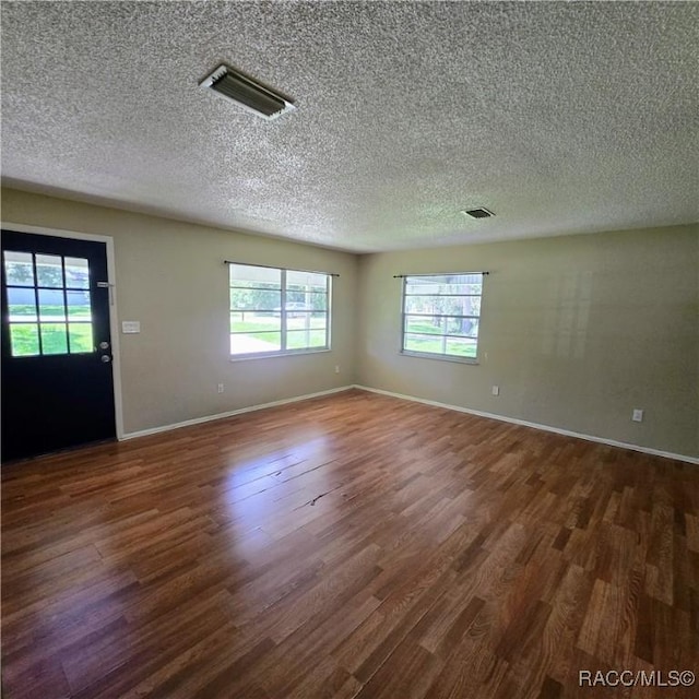 9227 N Fawn Way, Citrus Springs, FL 34434 - unfurnished room featuring dark wood-type flooring and a textured ceiling