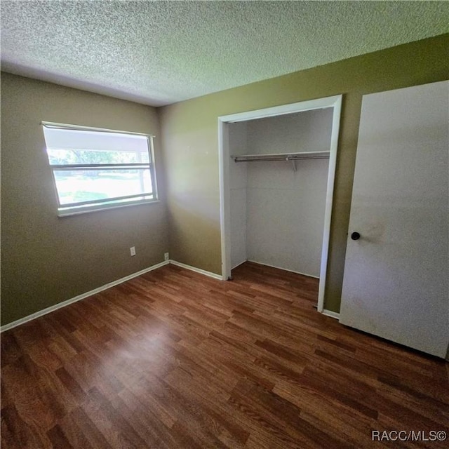 9227 N Fawn Way, Citrus Springs, FL 34434 - unfurnished bedroom featuring wood finished floors, a closet, and a textured ceiling