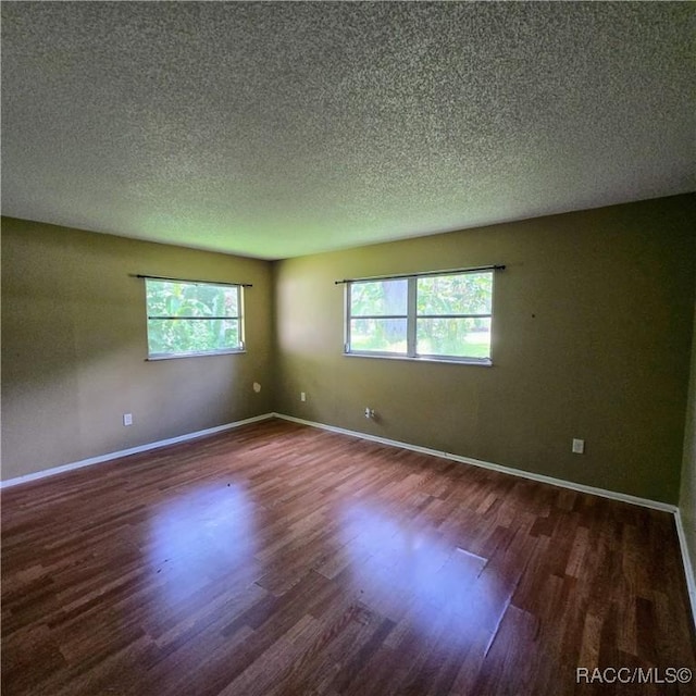 9227 N Fawn Way, Citrus Springs, FL 34434 - empty room with dark wood-style floors and a textured ceiling