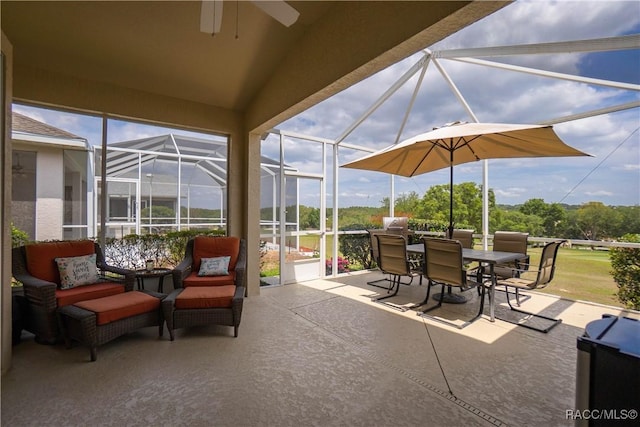 view of patio / terrace with an outdoor living space, a ceiling fan, outdoor dining area, and glass enclosure