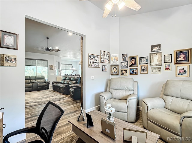 living room featuring ceiling fan and light wood-type flooring