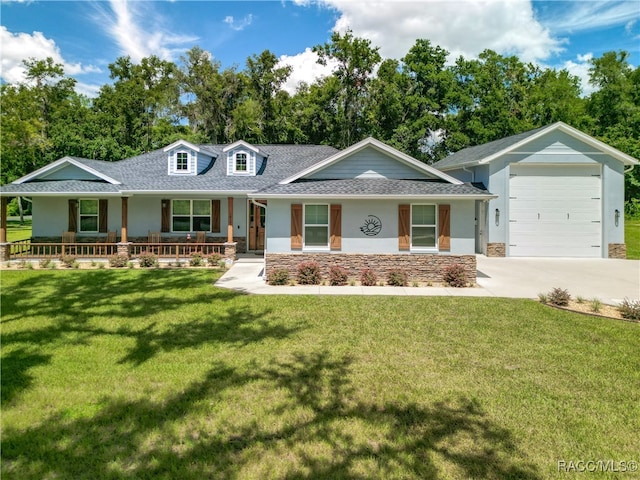 ranch-style house with covered porch, a garage, and a front yard