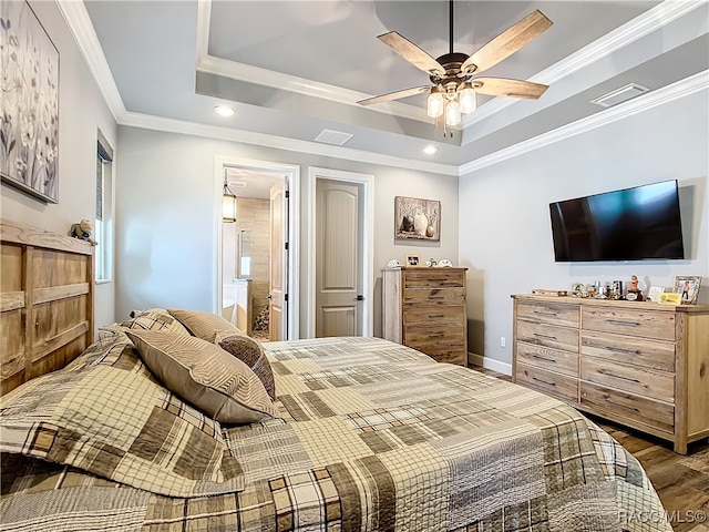 bedroom featuring ceiling fan, dark hardwood / wood-style flooring, ornamental molding, and ensuite bathroom