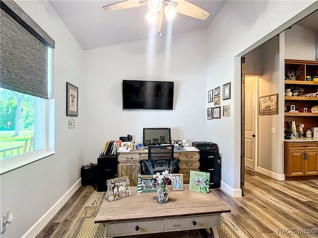 office featuring dark hardwood / wood-style floors, vaulted ceiling, and ceiling fan