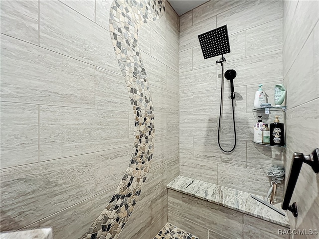 bathroom with tiled shower