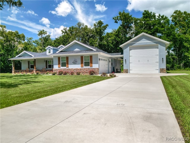 ranch-style house with covered porch, a garage, and a front yard