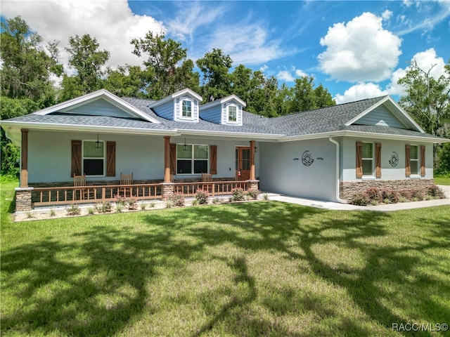 view of front of home featuring covered porch and a front yard