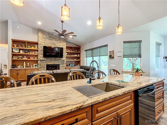 kitchen featuring ceiling fan, sink, light stone countertops, and lofted ceiling