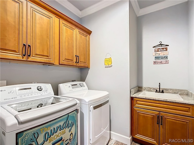 laundry area with sink, cabinets, hardwood / wood-style floors, washer and dryer, and ornamental molding