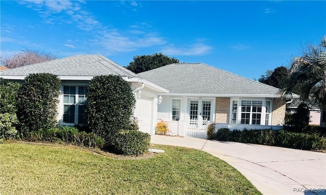 view of front of house featuring a front yard and a garage