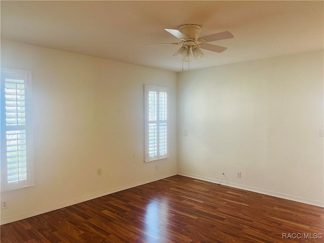 unfurnished room with ceiling fan and dark hardwood / wood-style flooring