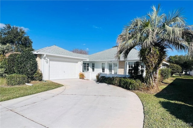 single story home with a front yard and a garage