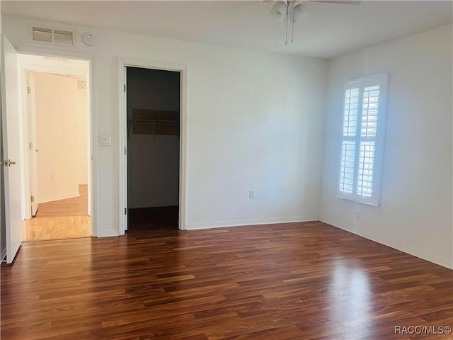 spare room featuring dark hardwood / wood-style flooring and ceiling fan