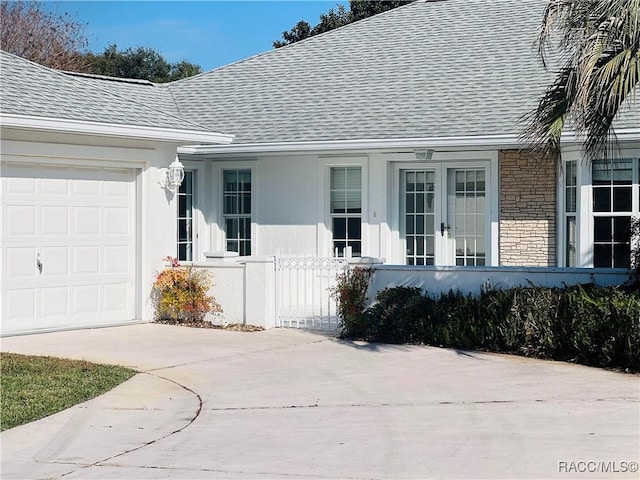 property entrance with french doors and a garage