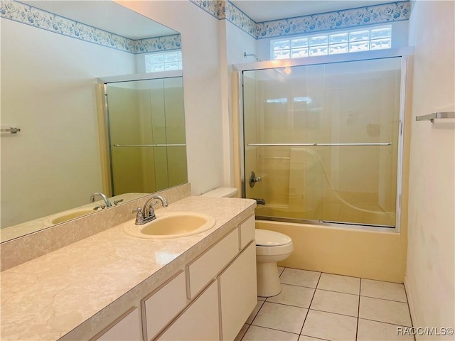 full bathroom featuring enclosed tub / shower combo, tile patterned flooring, vanity, and toilet