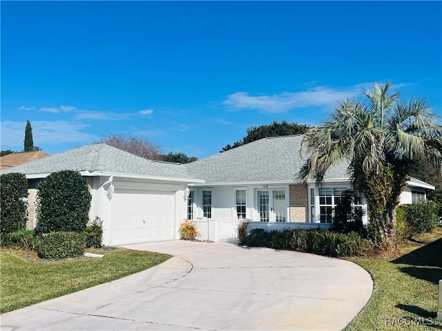 ranch-style house featuring a front lawn and a garage