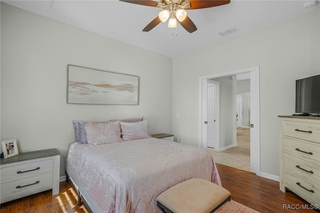 bedroom with dark wood-type flooring, visible vents, baseboards, and a ceiling fan