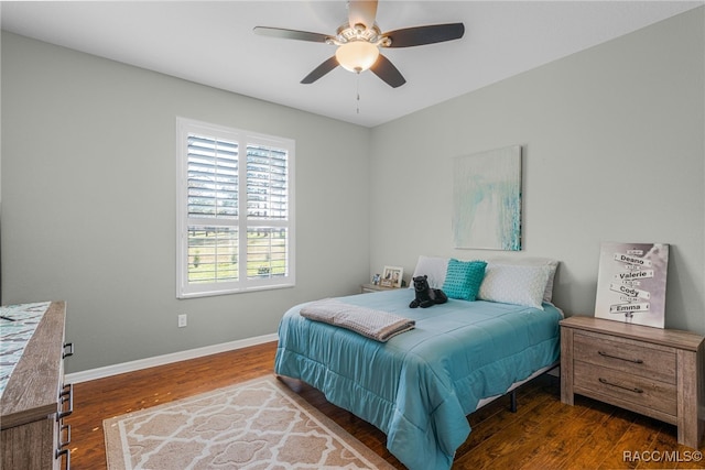 bedroom featuring ceiling fan, baseboards, and wood finished floors