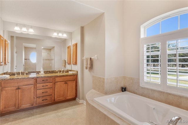 bathroom with a bath, a stall shower, a healthy amount of sunlight, and a sink