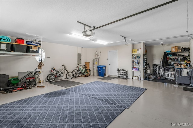 garage featuring water heater, electric panel, and a garage door opener