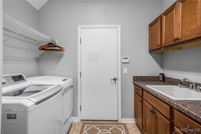 laundry room with washer and clothes dryer, a sink, and cabinet space