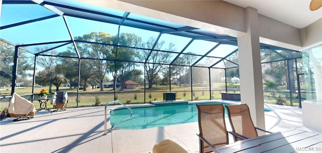 outdoor pool featuring glass enclosure and a patio