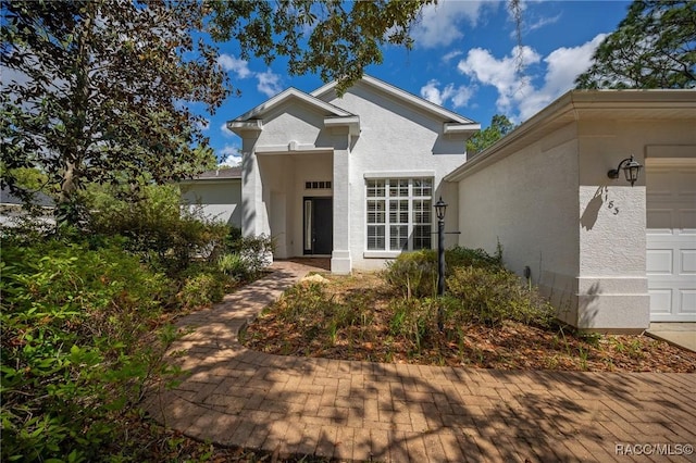 view of front of property featuring stucco siding and a garage