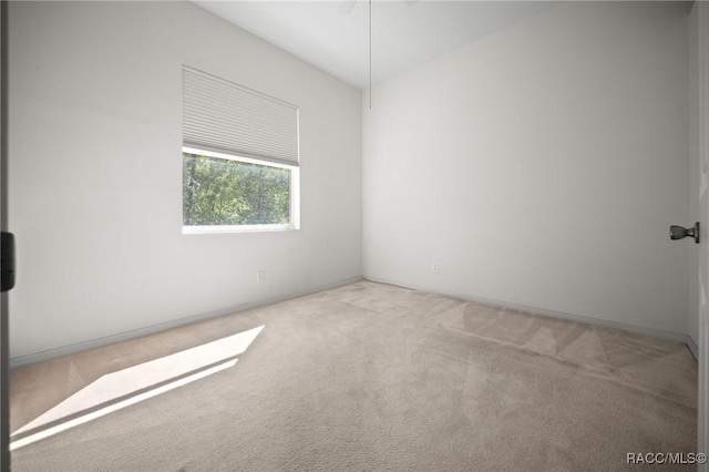 unfurnished room with carpet floors and baseboards