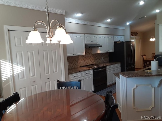 kitchen with an inviting chandelier, backsplash, decorative light fixtures, white cabinets, and black appliances