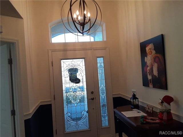 entryway featuring an inviting chandelier