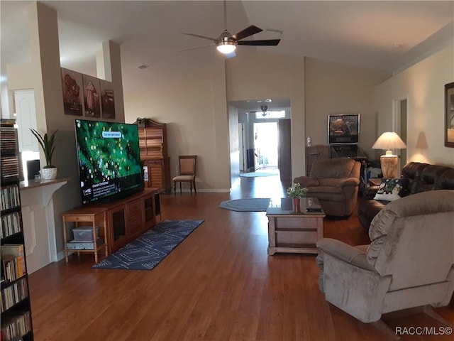 living room with wood-type flooring, vaulted ceiling, and ceiling fan