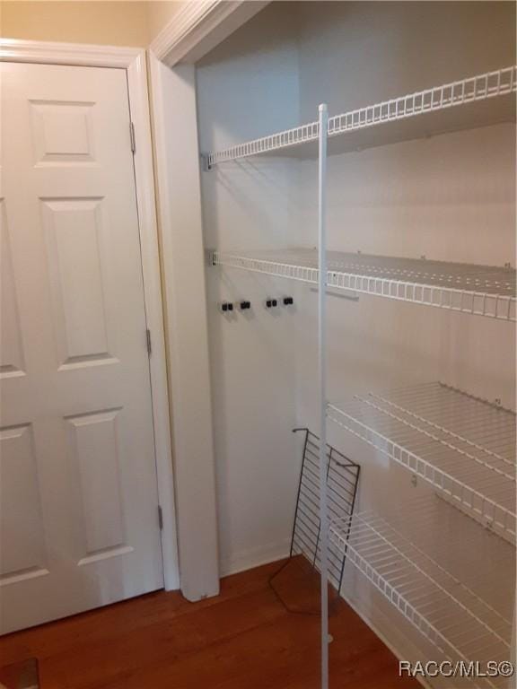 laundry area with hardwood / wood-style floors